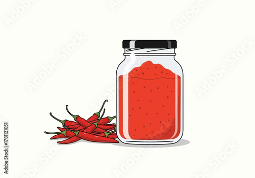 Jar of chili paste sits by pile of fresh red chili peppers