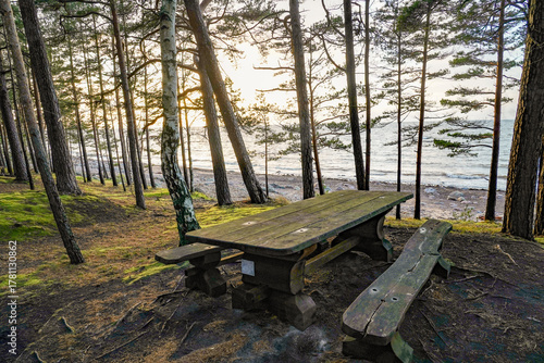 Fototapeta Naklejka Na Ścianę i Meble -  wooden table with benches on the seashore