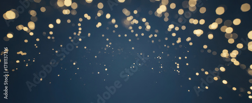 holiday illumination and decoration concept - christmas garland bokeh lights over dark blue background
