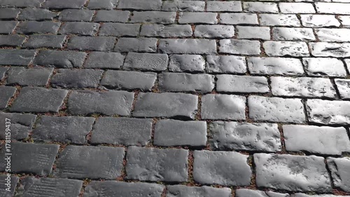 Historic cobblestone pavement on Red Square Moscow with weathered gray stones. Ancient worn stone blocks with natural lighting showing texture and age. Traditional Russian street surface in famous lan