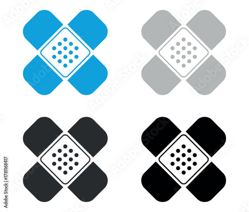 Four different colored adhesive bandages, symbolizing first aid and healing concepts.