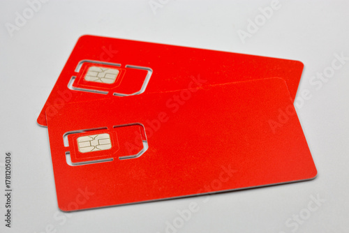 Two red SIM cards closeup on white background.