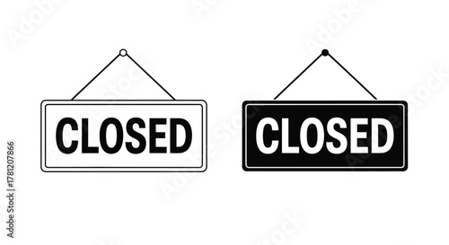 Two signs, one black and one white, displaying the word CLOSED hanging from strings