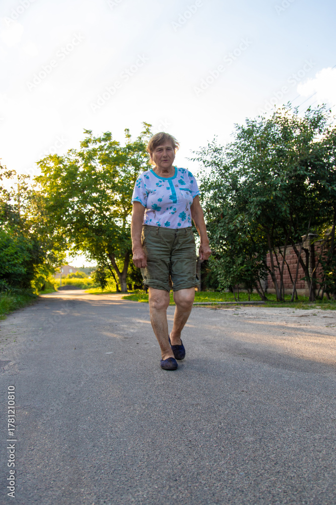 Fototapeta premium Old woman hurts her knee. Selective focus.