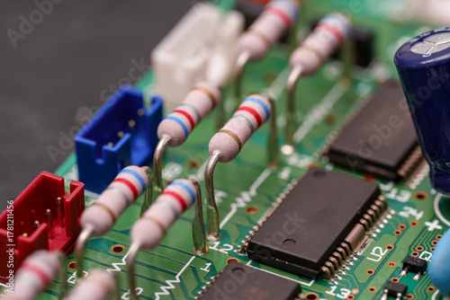 Obraz na plátně Peeking into the inner workings of a green circuit board, featuring resistors, c