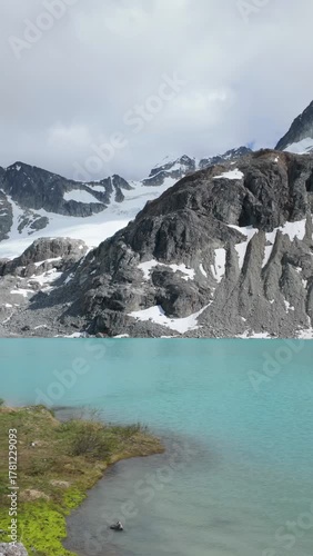 Turquoise Waters of Wedgemount Lake in Whistler with Snow-Capped Mountains and Rushing Stream in BC, Canada