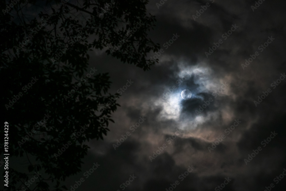 Naklejka premium Mysterious Moon Behind Dark Clouds
