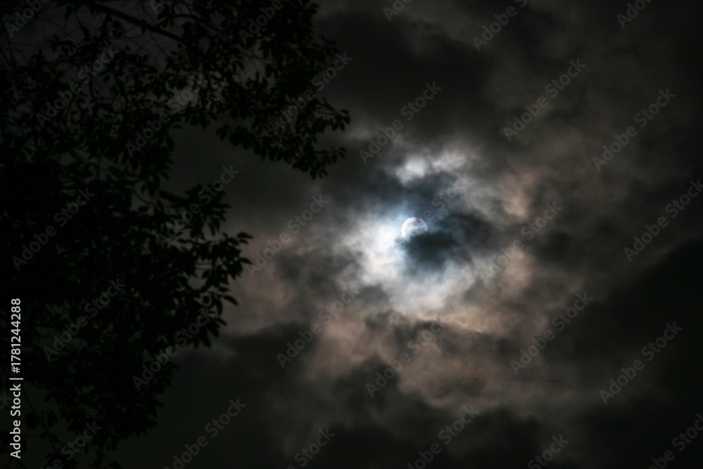 Fototapeta premium Mysterious Moon Behind Dark Clouds Night