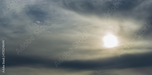 Dark gray and smoky clouds obscure the morning sun.