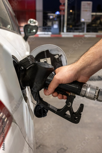Man Refueling a Car at Gas Station