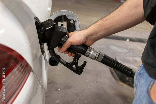 Man Refueling a Car at Gas Station
