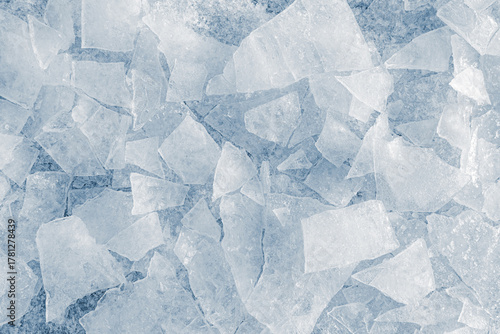 Shards of crushed thin ice in a light-blue tone. Background texture.