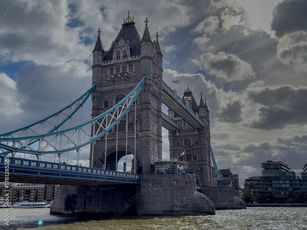 Obraz premium Stunning aerial view of Tower Bridge in London, spanning the River Thames with the city skyline in the background — blending historic architecture and modern urban beauty. London Bridge