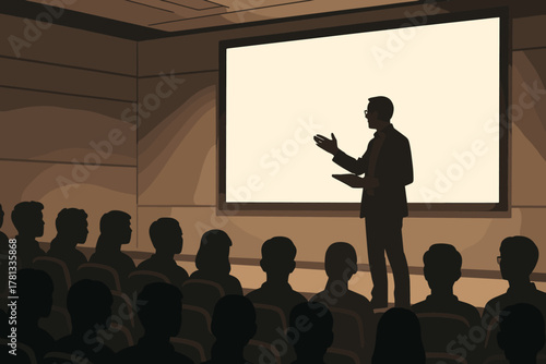 A male speaker stands in silhouette delivering a presentation to an audience seated in a dimly lit conference room.