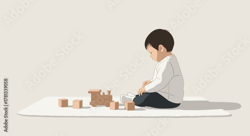 Young asian child plays quietly on a soft rug with wooden blocks and a toy train, wearing a white shirt and dark pants in a minimalist setting.