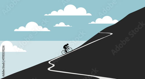 Silhouette of a cyclist riding uphill on a winding mountain road against a backdrop of clouds and blue sky.