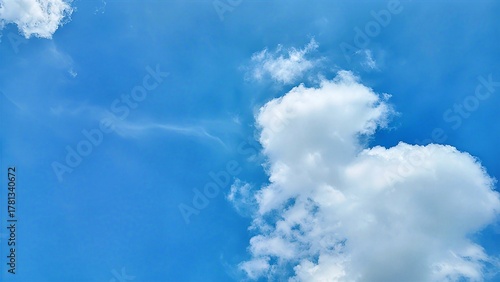 Clouds in the sky. Soft white clouds float peacefully across a bright blue sky, capturing the calm beauty of a sunny tropical day. Perfect serene background symbolizing clarity, hope, and fresh air