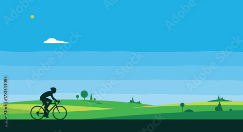 Silhouette of a cyclist riding through a green landscape under a clear blue sky with distant hills and trees.
