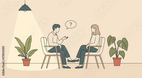 Two adults sitting on chairs engaging in a conversation, with indoor plants nearby under a ceiling lamp.
