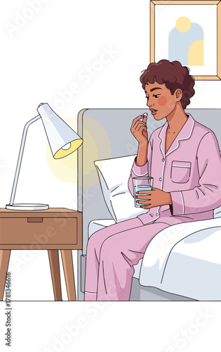 Woman in pajamas taking medication before bed.