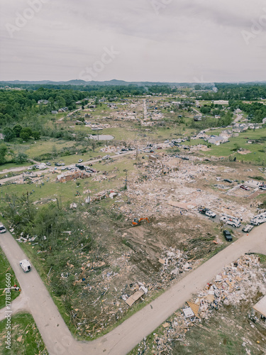 Aerial drone view of tornado-damage path through suburban neighbourhood