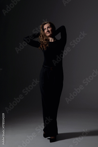 Wallpaper Mural Sensual young woman with makeup and hairstyle in elegant suit, posing in studio, dark lights. Torontodigital.ca
