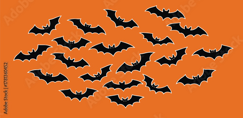 Spooky Halloween Bats Flying Across an Orange Background - A Frightful Night Scene