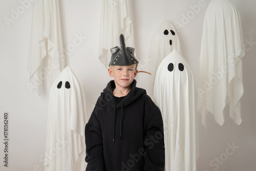 Child in costume surrounded by ghostly figures