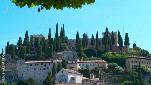 Cityscape of Verona with the Castel San Pietro surrounded by lush cypress trees
