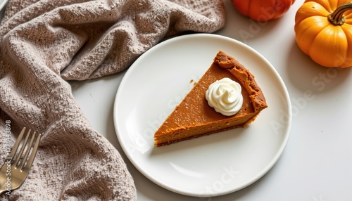 Perfect Slice of Pumpkin Pie with Whipped Cream, holiday dessert on a clean white plate for stock photo use.