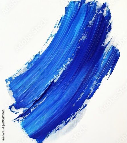 Abstract blue paint brush stroke with varying shades and textured edges on white background, evoking calm and dynamic movement