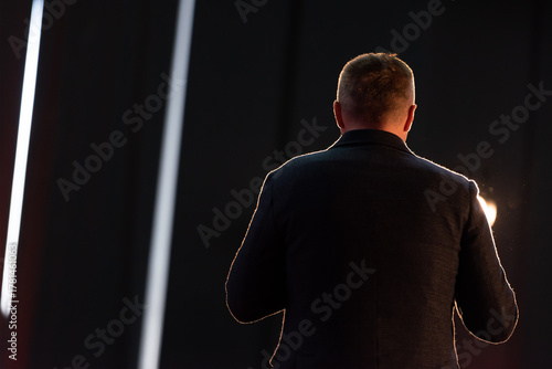 Business speaker giving presentation on stage at conference