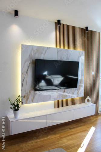 Photos Modern living room featuring marble and wood textures, indirect LED lighting, and minimal decor for a refined look