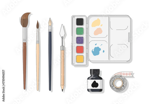 Art supplies brushes palette ink and tape arranged on a white background