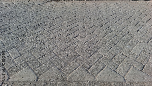 Fototapeta Naklejka Na Ścianę i Meble -  Detailed Close-up Worn Paving Road Texture, Grunge Small Stone Street Surface Background Wallpaper	