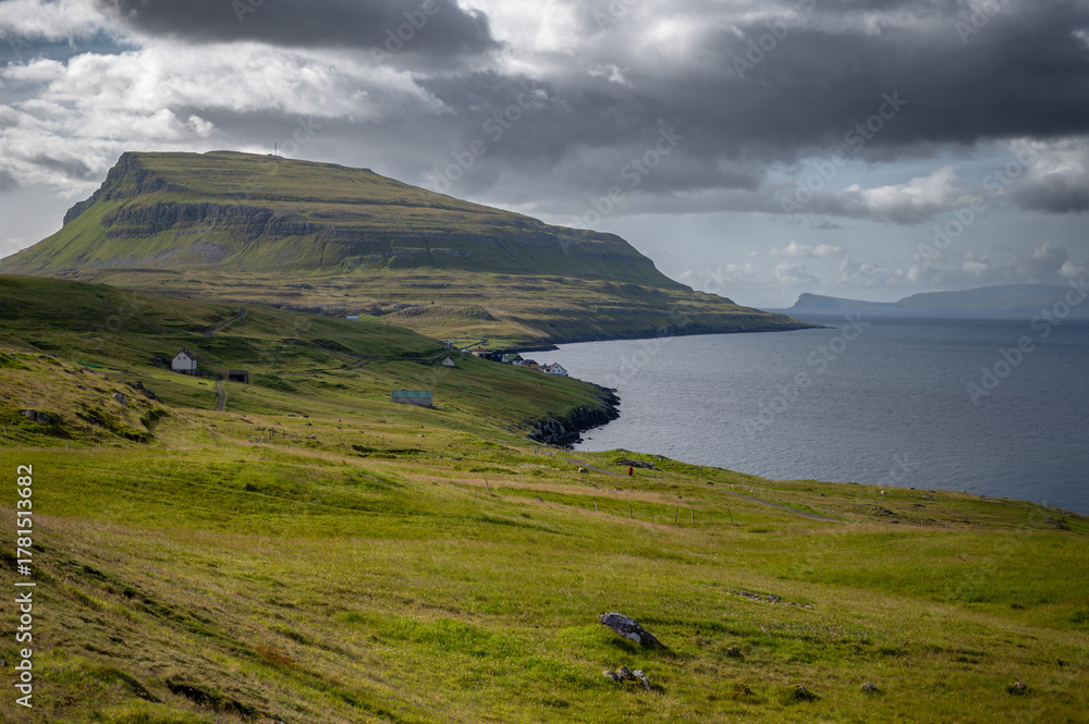 Obraz premium Low clouds hang over the remote Scandinavian island of Nolsoy in the Faroe Islands