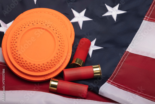 Bild auf Leinwand Clay shooting target with shotgun shells on usa flag background , Shotgun game