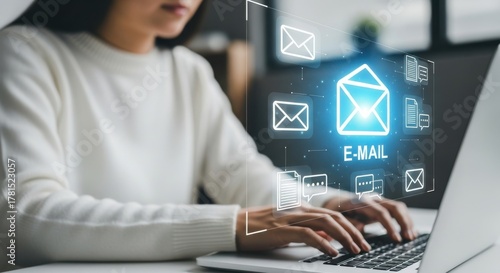 Digital Email Marketing: Woman Typing on Laptop with Glowing Email Icon Surrounded by Message Icons for Online Communication and Business Strategy