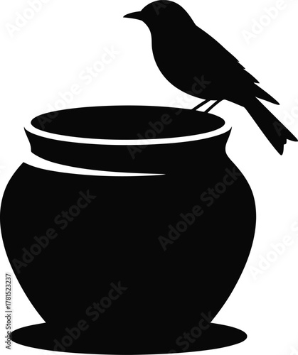Elegant silhouette of a bird perched on a decorative pottery jar