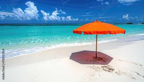 Vibrant Orange Beach Umbrella Stands on a White Sandy Shore Beside Turquoise Ocean Waters Under Bright Daylight Sky With Fluffy Clouds