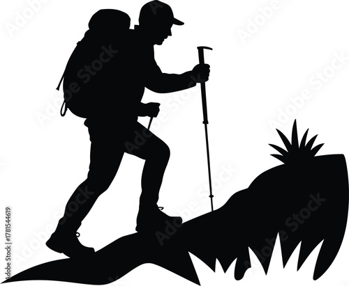 Silhouette of a hiker with backpack and poles on a mountain trail