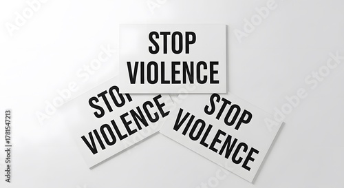 Three signs display STOP VIOLENCE in bold letters, promoting peace