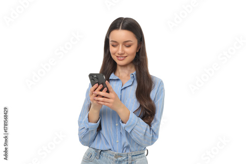 Woman enjoys using her smartphone while standing and smiling, PNG