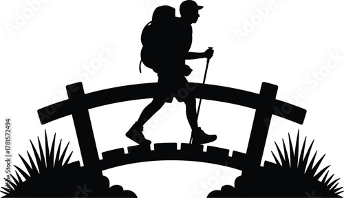 Hiker with trekking poles crossing a bridge silhouette
