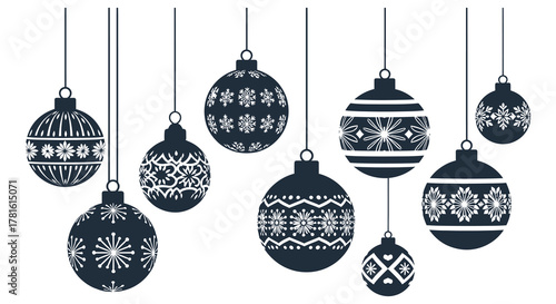 Collection of dark christmas ornaments with intricate white snowflake patterns hanging silhouette