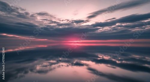 Fototapeta Naklejka Na Ścianę i Meble -  Dramatic Sunset Over Calm Ocean with Reflective Surface.