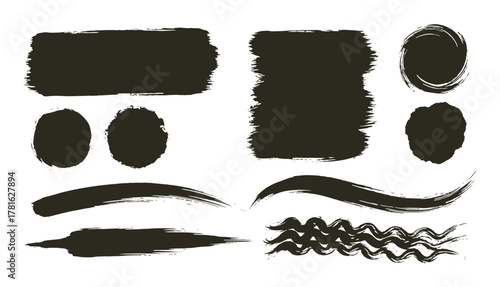 Collection of black paint brush strokes and grunge ink textures on white background for artistic design