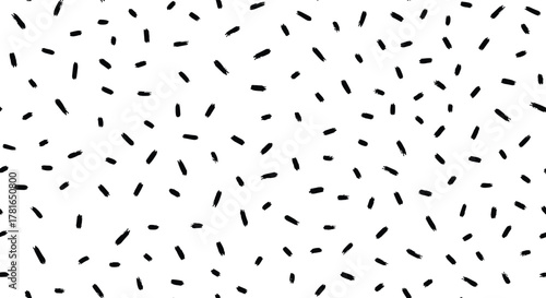 Abstract pattern of hand-drawn black dash strokes scattered randomly on a white background, creating a playful and modern design.