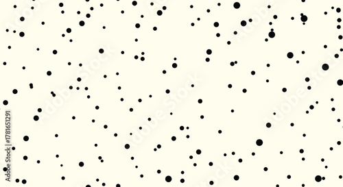 Scattered black dots of varying sizes create a simple, minimalist, and abstract pattern on a pale cream background.