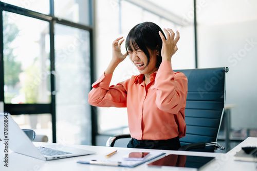 Canvastavla Stressed Asian Businesswoman Feeling Overworked at office desk with laptop